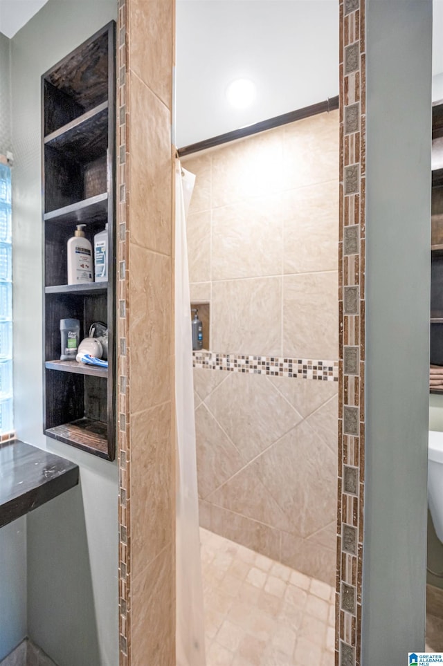 bathroom with a shower with curtain and toilet