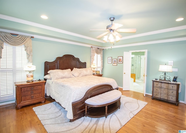 bedroom featuring ceiling fan, crown molding, ensuite bathroom, and wood-type flooring