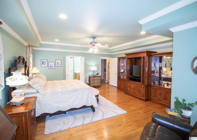 bedroom featuring ceiling fan, light hardwood / wood-style floors, a raised ceiling, and ornamental molding