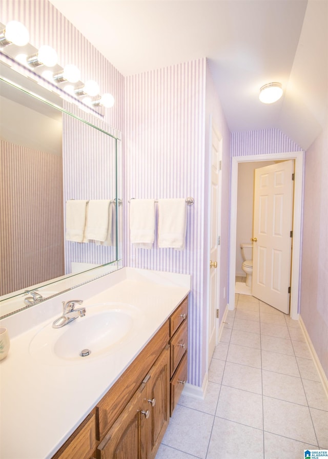 bathroom featuring toilet, vanity, and tile patterned floors