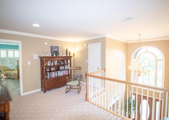 hallway with ornamental molding, light colored carpet, and a notable chandelier