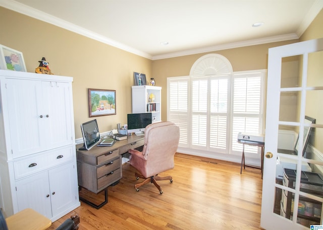 home office with crown molding and light hardwood / wood-style floors