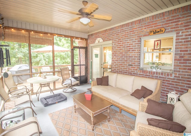 living room featuring ceiling fan, wood ceiling, and brick wall