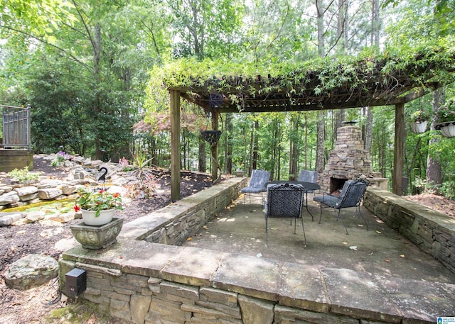 view of patio / terrace featuring an outdoor stone fireplace