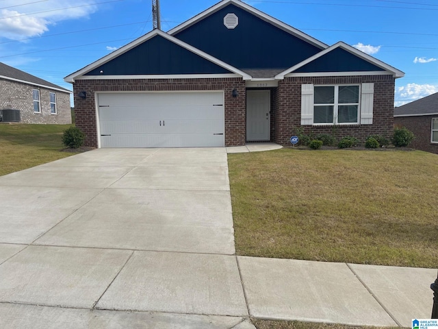 view of front of property with a garage, cooling unit, and a front lawn