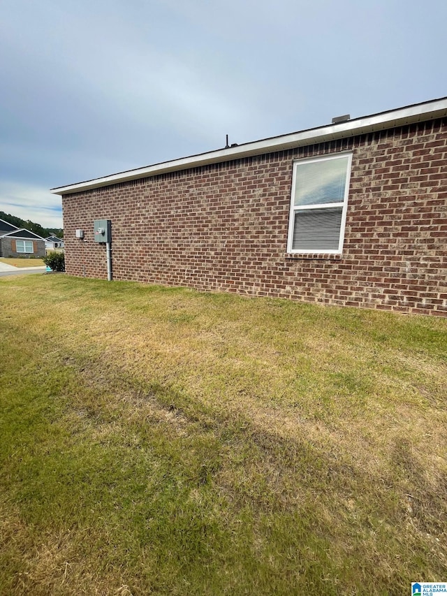 view of side of home featuring a yard