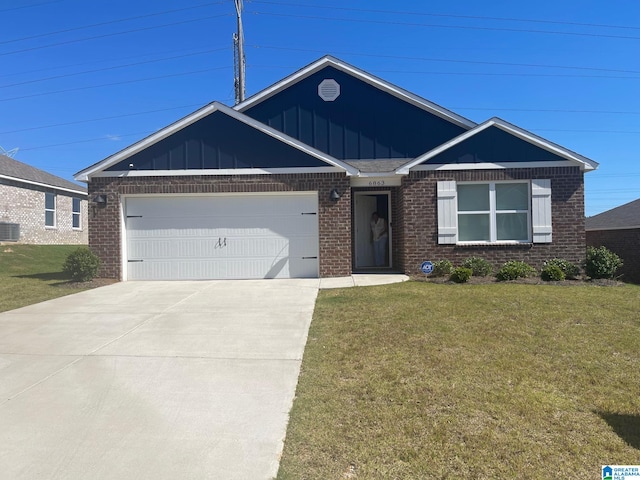 view of front of property featuring central air condition unit, a front yard, and a garage