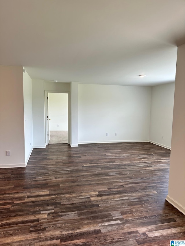 spare room with dark hardwood / wood-style flooring