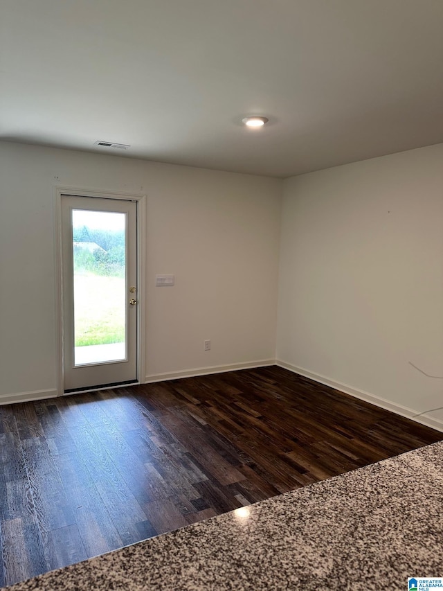 spare room featuring dark hardwood / wood-style flooring