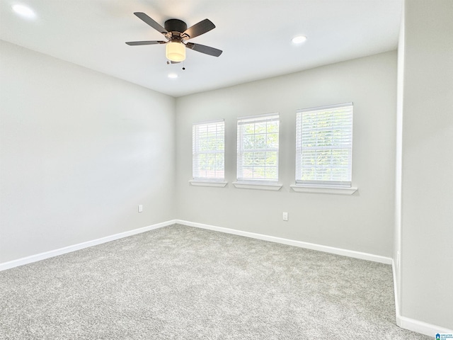 carpeted spare room with ceiling fan and a healthy amount of sunlight