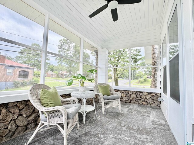 sunroom featuring ceiling fan and wooden ceiling