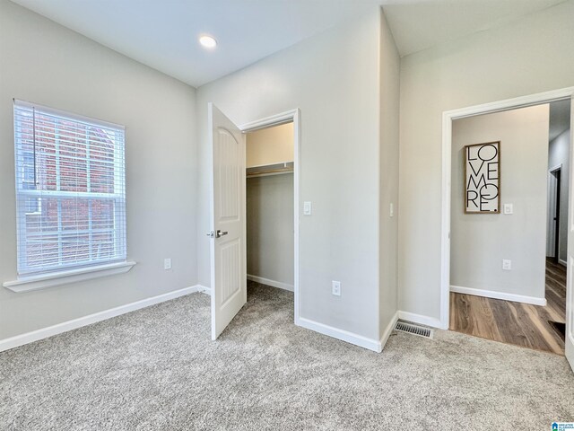 unfurnished bedroom with carpet flooring and a closet