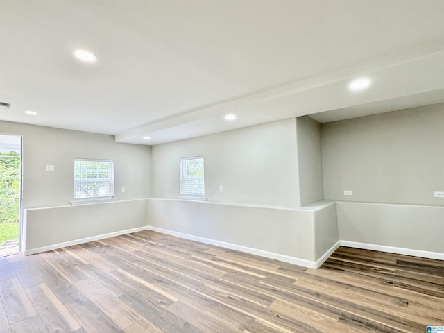 unfurnished room with hardwood / wood-style flooring