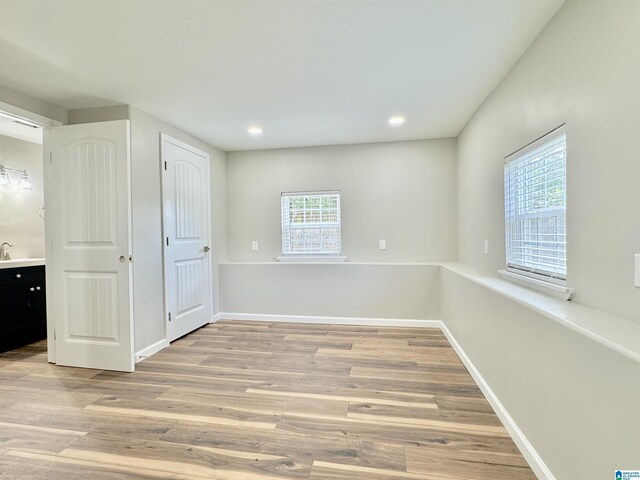 empty room with light hardwood / wood-style flooring