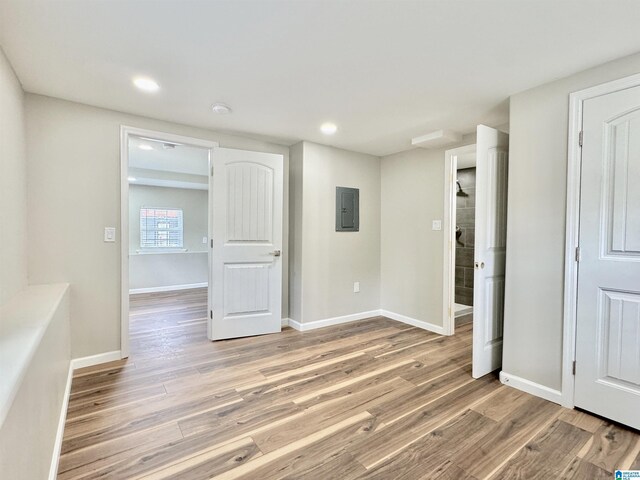 unfurnished bedroom featuring electric panel and light wood-type flooring