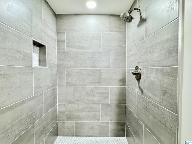 bathroom with a tile shower