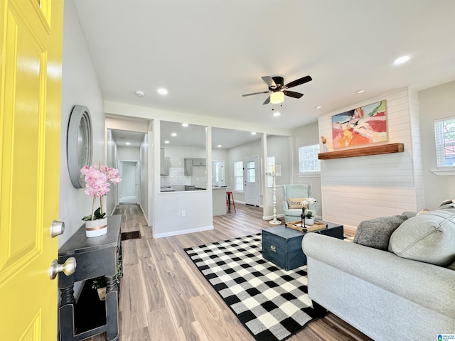 living room with ceiling fan and light hardwood / wood-style floors