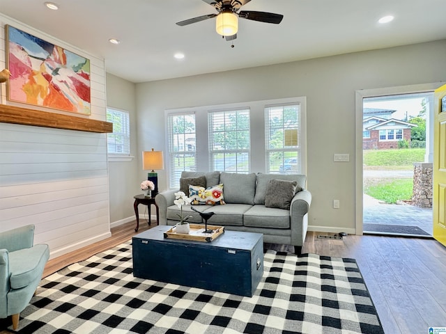 living room featuring ceiling fan and light hardwood / wood-style floors