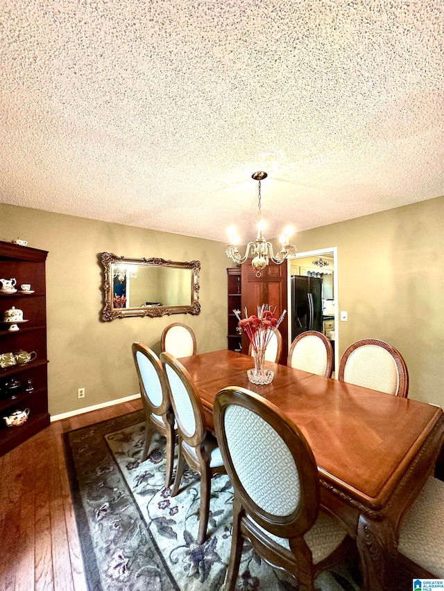 dining room featuring an inviting chandelier, a textured ceiling, and hardwood / wood-style floors