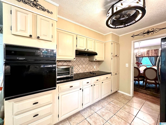 kitchen featuring light hardwood / wood-style flooring, tasteful backsplash, a textured ceiling, black appliances, and ornamental molding