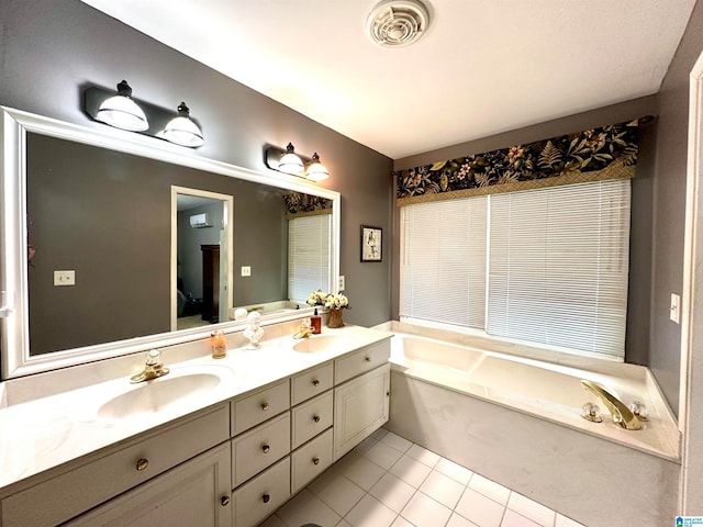 bathroom with double vanity, tile patterned floors, and a bathtub