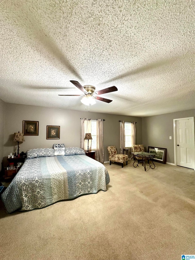 carpeted bedroom with a textured ceiling and ceiling fan