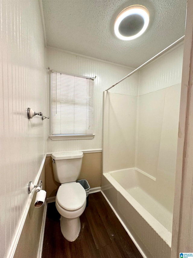 bathroom featuring a textured ceiling, toilet, wood-type flooring, and shower / tub combination