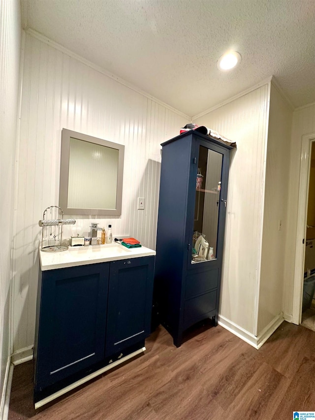 bathroom with vanity, a textured ceiling, and hardwood / wood-style floors