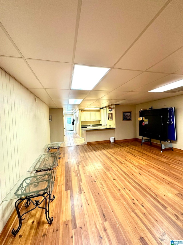 interior space with light hardwood / wood-style floors and a paneled ceiling