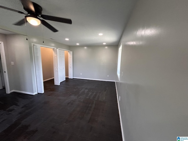 unfurnished bedroom with recessed lighting, a ceiling fan, baseboards, and dark wood-style flooring