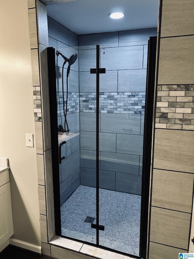 bathroom with baseboards and a stall shower