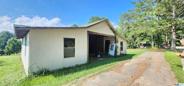 view of side of home featuring a yard