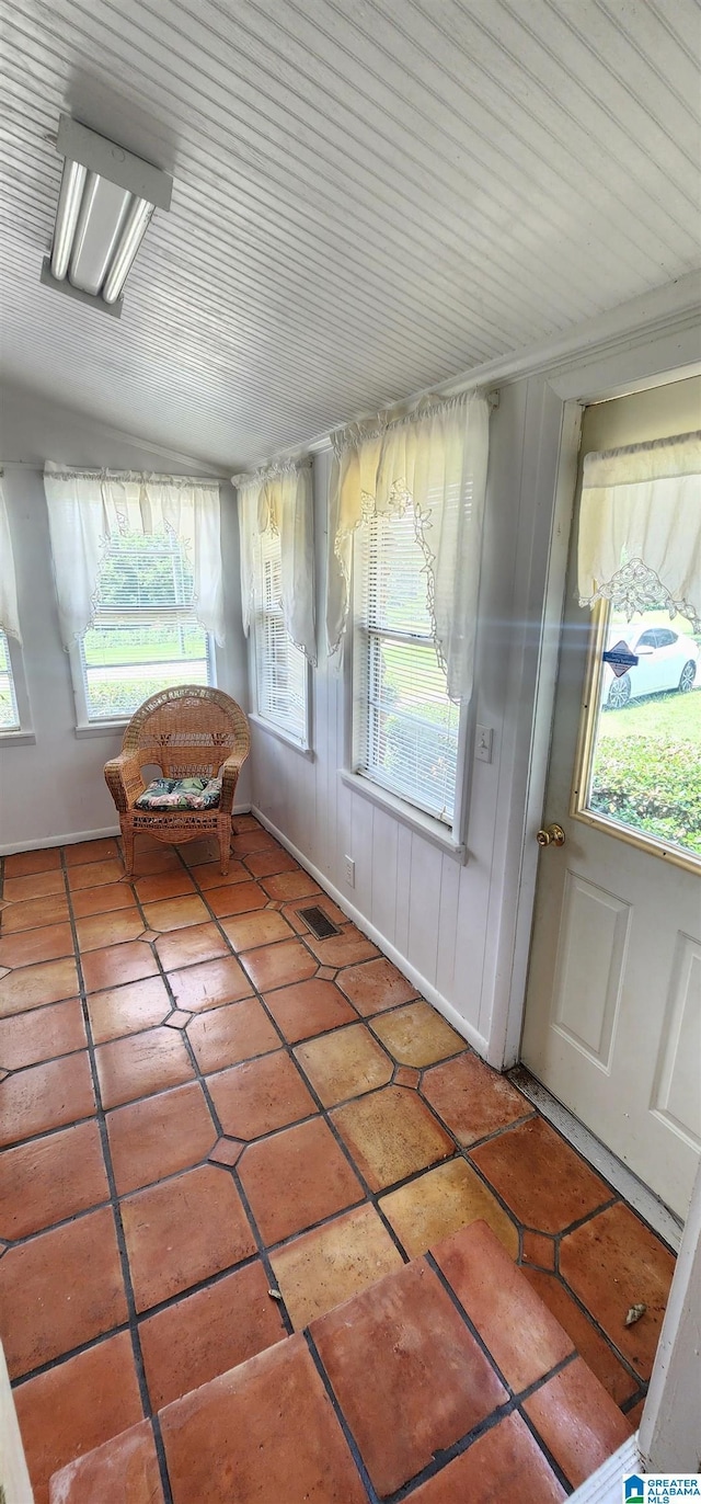 unfurnished sunroom with wood ceiling