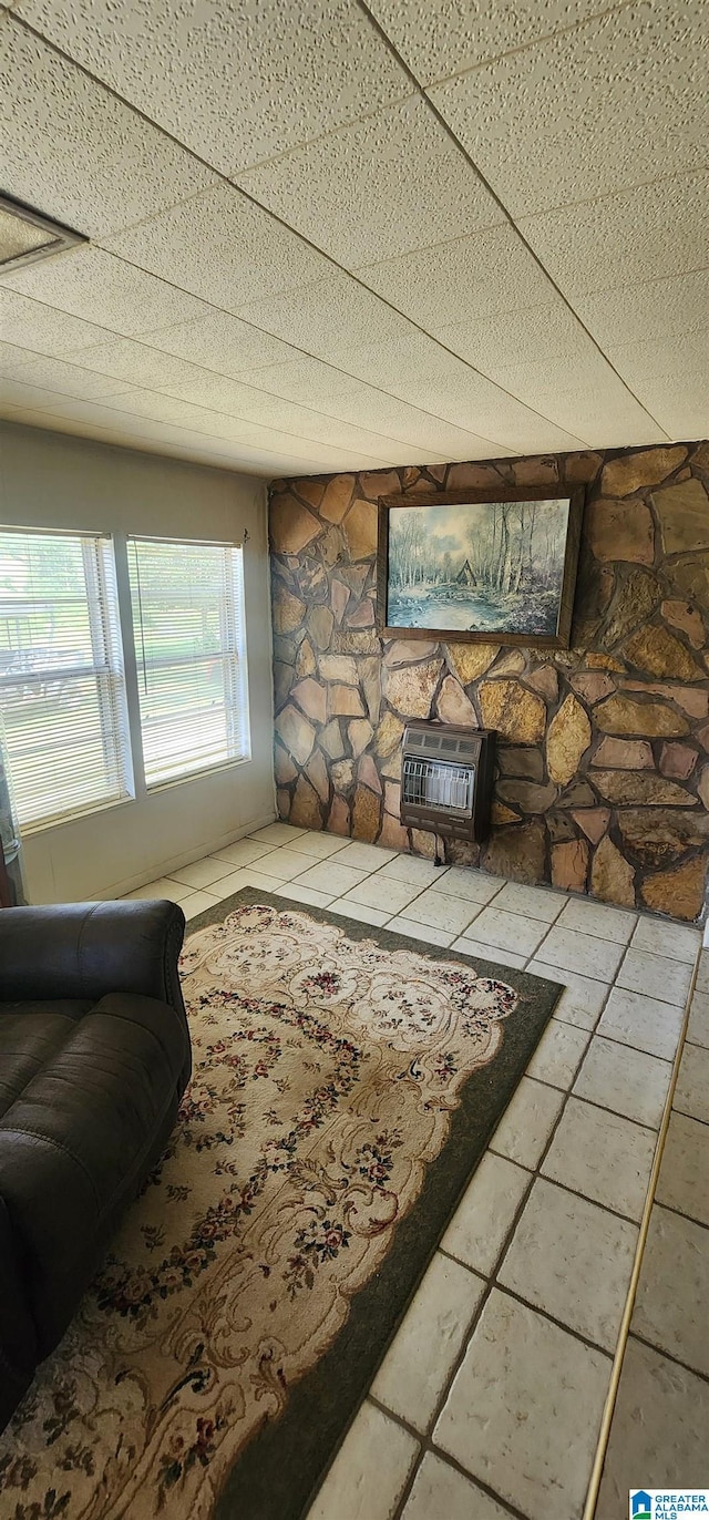 tiled living room featuring heating unit