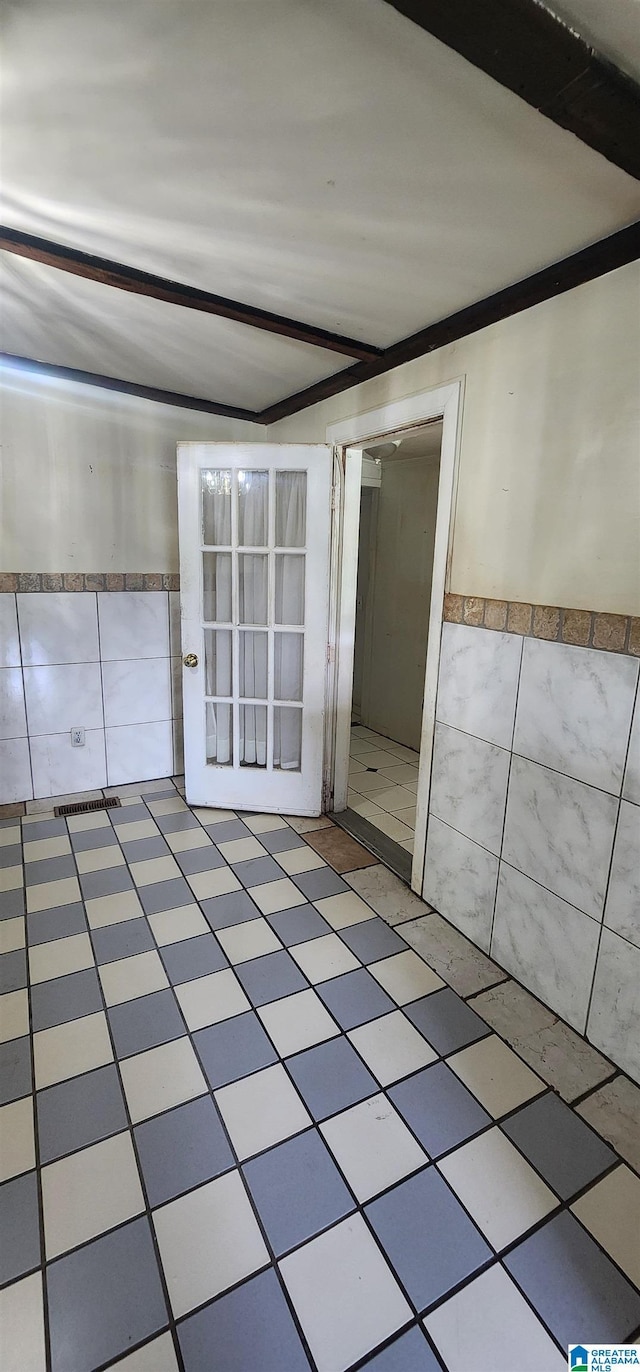 empty room featuring tile walls