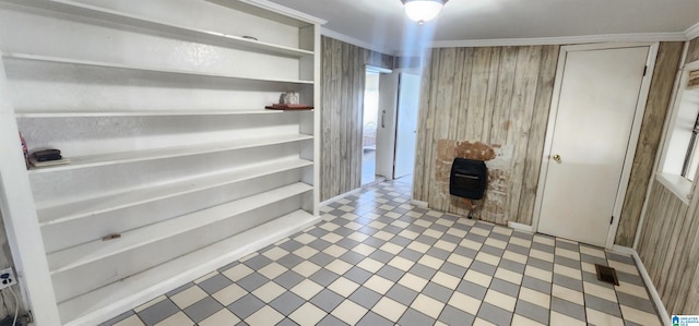 corridor with ornamental molding and wooden walls