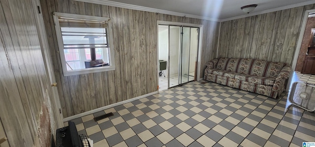 unfurnished living room featuring ornamental molding and wood walls