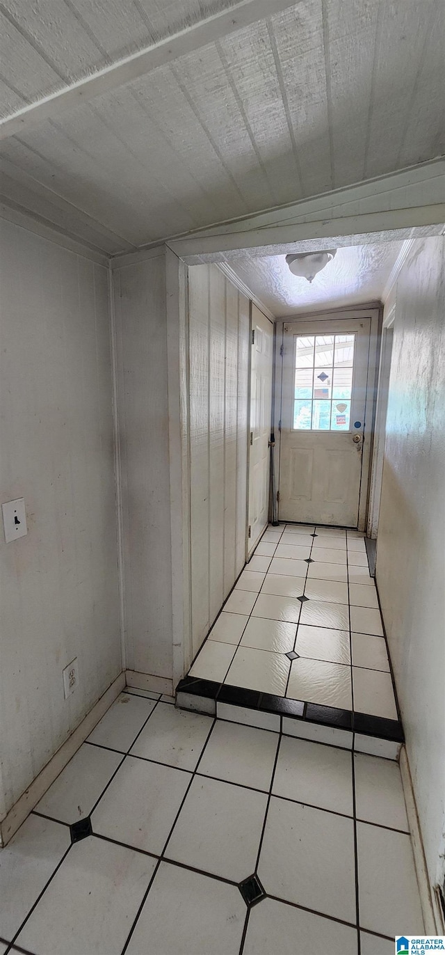 hall with light tile patterned floors