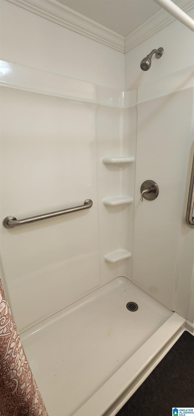 bathroom featuring crown molding and a shower with shower curtain