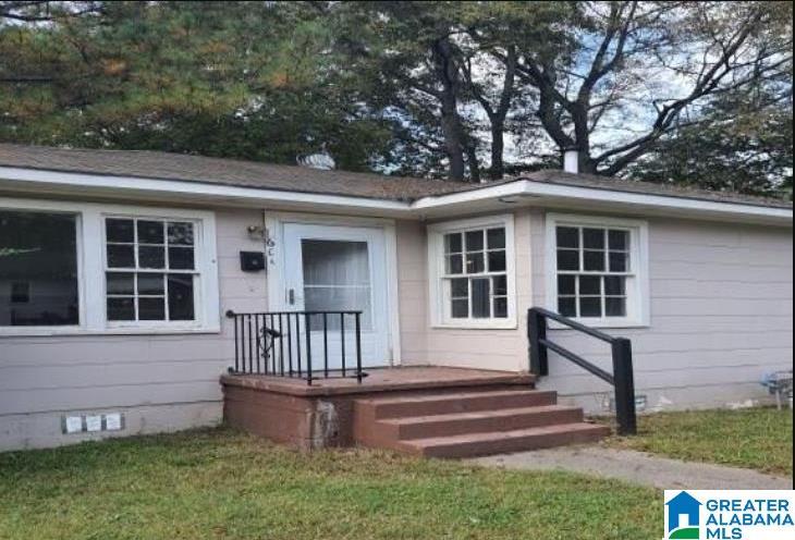 doorway to property with a yard