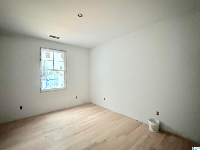 unfurnished room with light wood-type flooring