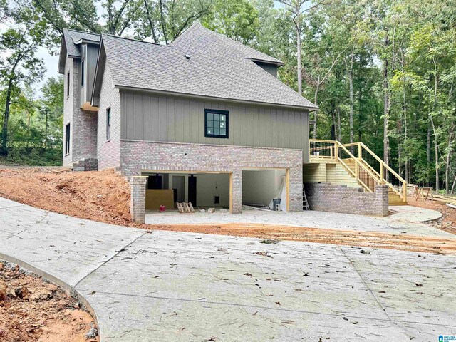 back of property with a garage