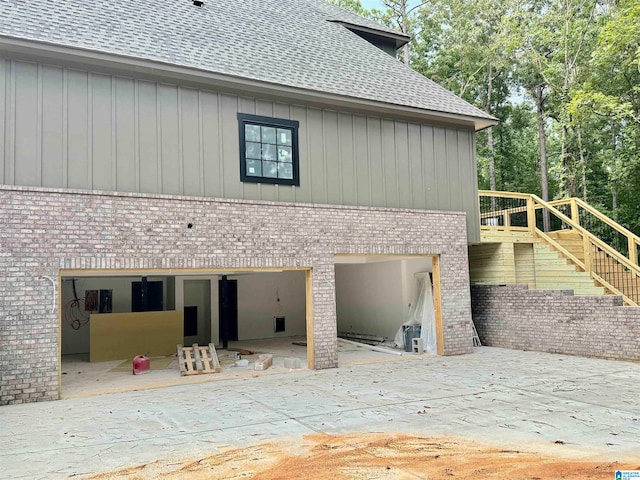 back of property with a patio and a garage