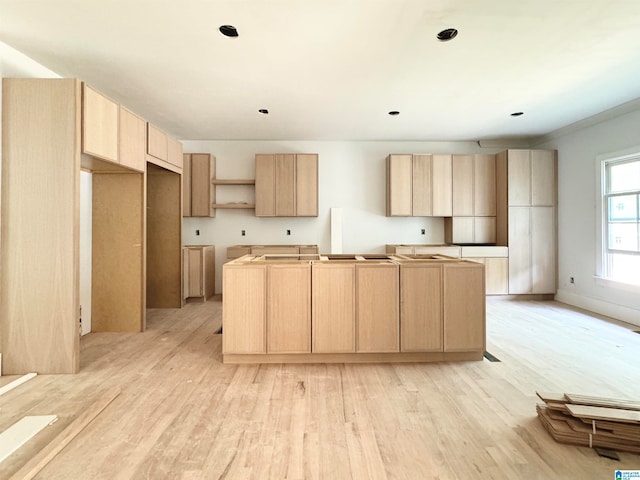 kitchen featuring light hardwood / wood-style floors, light brown cabinetry, and a kitchen island