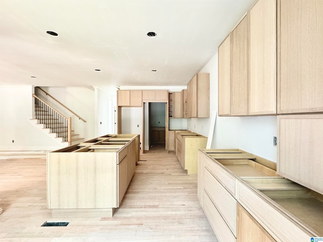 kitchen featuring light hardwood / wood-style flooring and light brown cabinets