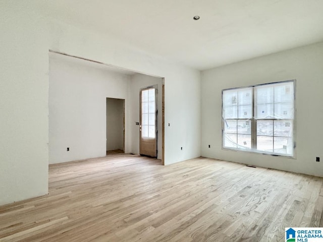 empty room with light hardwood / wood-style flooring