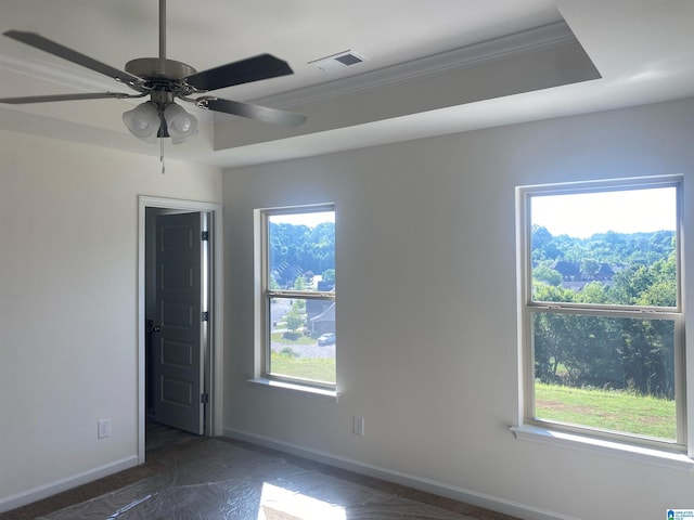 spare room featuring ornamental molding, visible vents, and baseboards