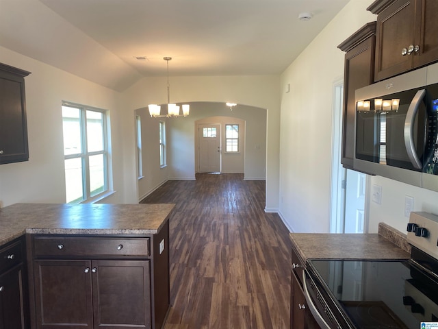 kitchen featuring pendant lighting, lofted ceiling, appliances with stainless steel finishes, dark brown cabinetry, and plenty of natural light