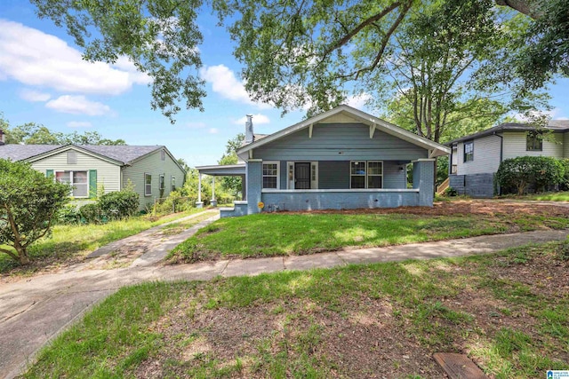 bungalow-style house with a front lawn and a porch