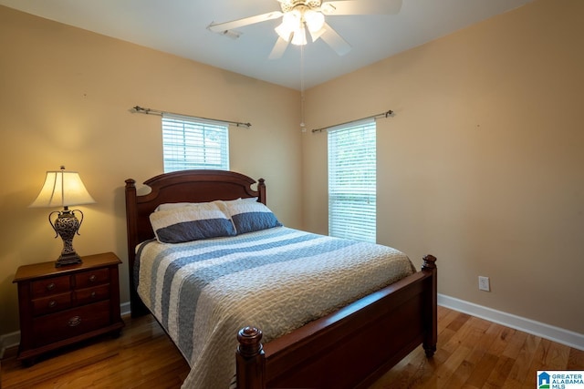 bedroom with wood-type flooring and ceiling fan